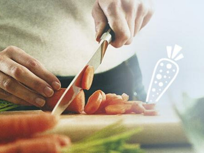 man cutting carrots